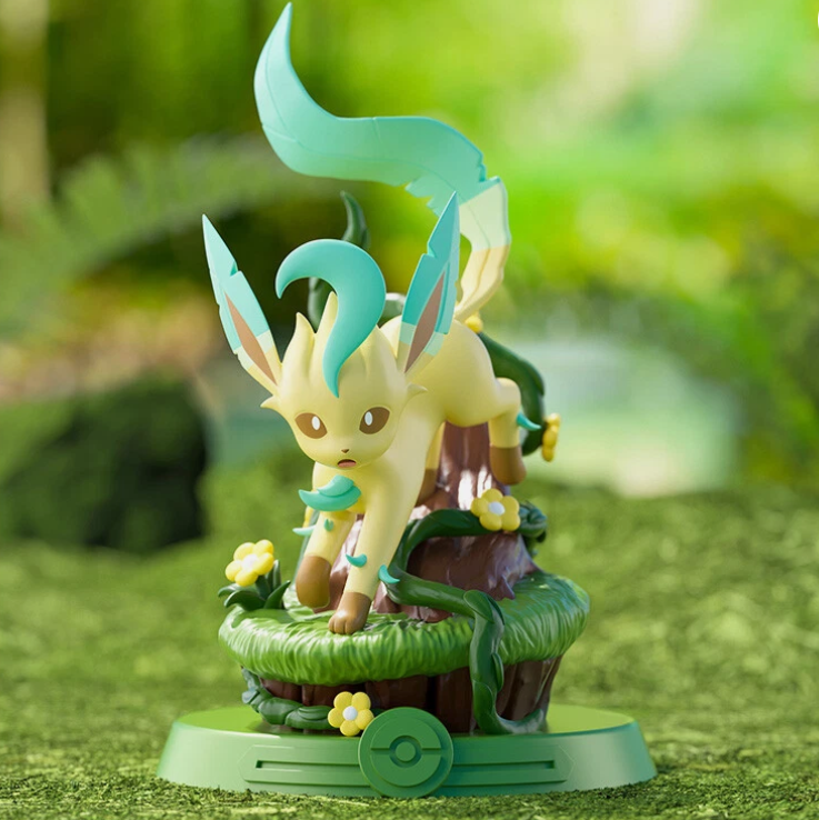 Toy figure of a dragon-like creature on a grassy platform with a blurred green background